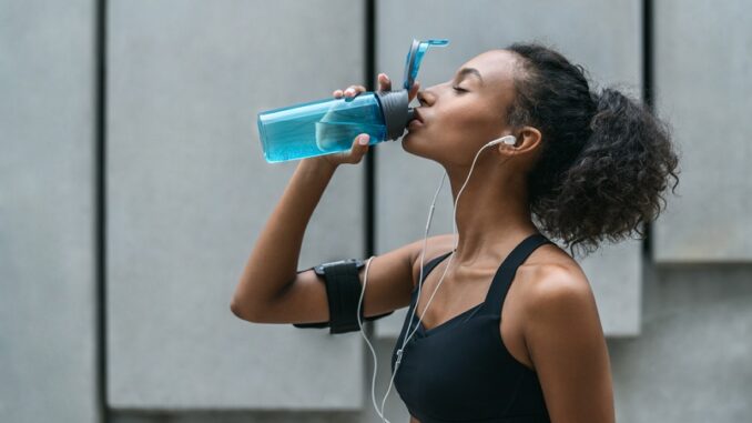 Fitness woman drinking water from a bottle after workout standing by a grey wall The case of hydrogen water well-illustrates that, often, it is what is added to the water which can truly optimize the substance. As well as hydration, there are several other things an athlete will look for in a drink. A speedy replenishment of energy is one